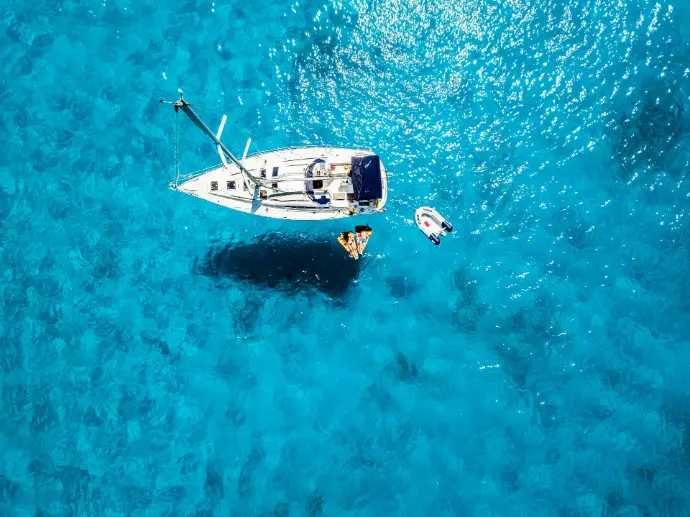 white yacht in middle of blue sea